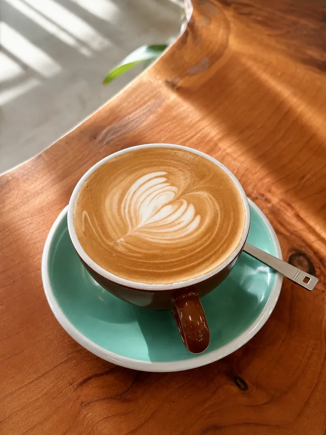 Latte art in a green cup at Silos Cafe