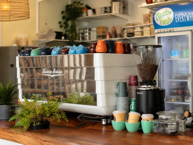 The espresso machine, grinder and colourful cups at Silos Cafe