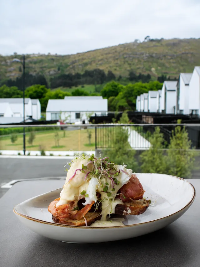 Eggs and bacon on toast with the valley in the background