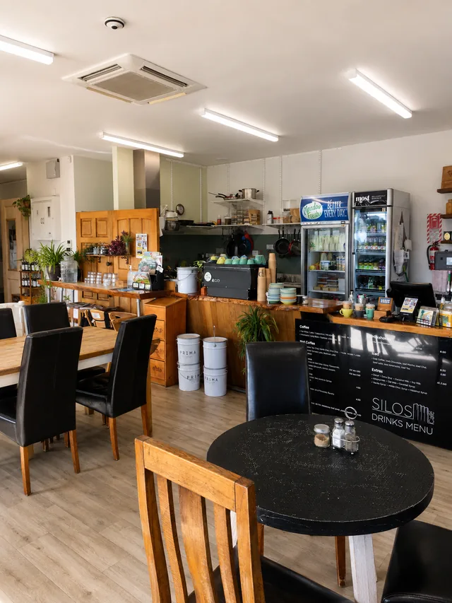 Coffee counter, drinks menu and tables inside Silos Cafe